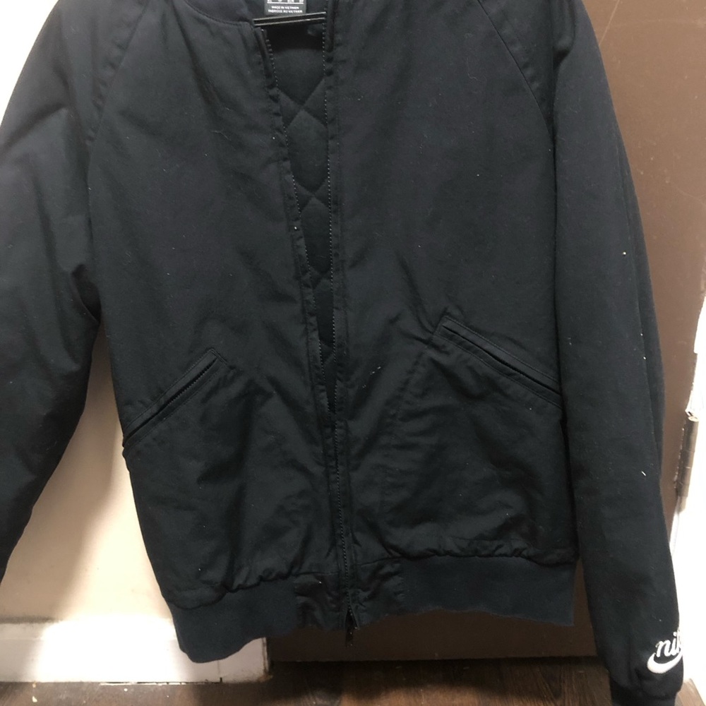 Plain black Nike flight jacket quilted with Nike logo on sleeve